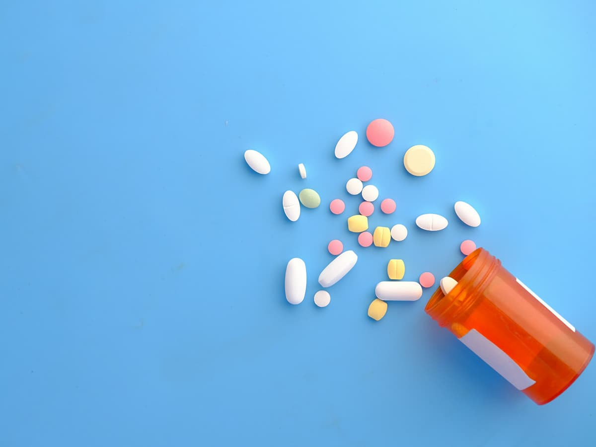 medication bottle and pills spilling out