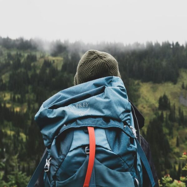 teen with backpack in forest