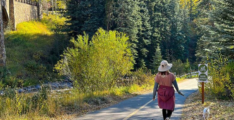 paved trail in Vail with woman walking dog