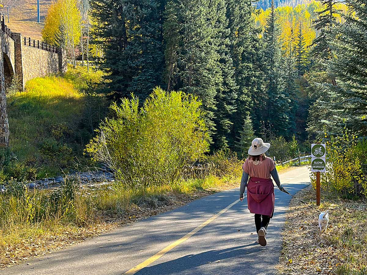 paved trail in Vail with woman walking dog