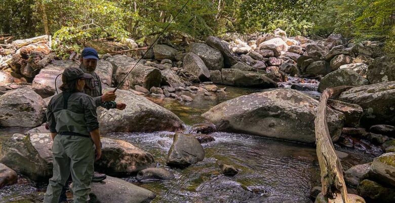 woman and man talking at a stream