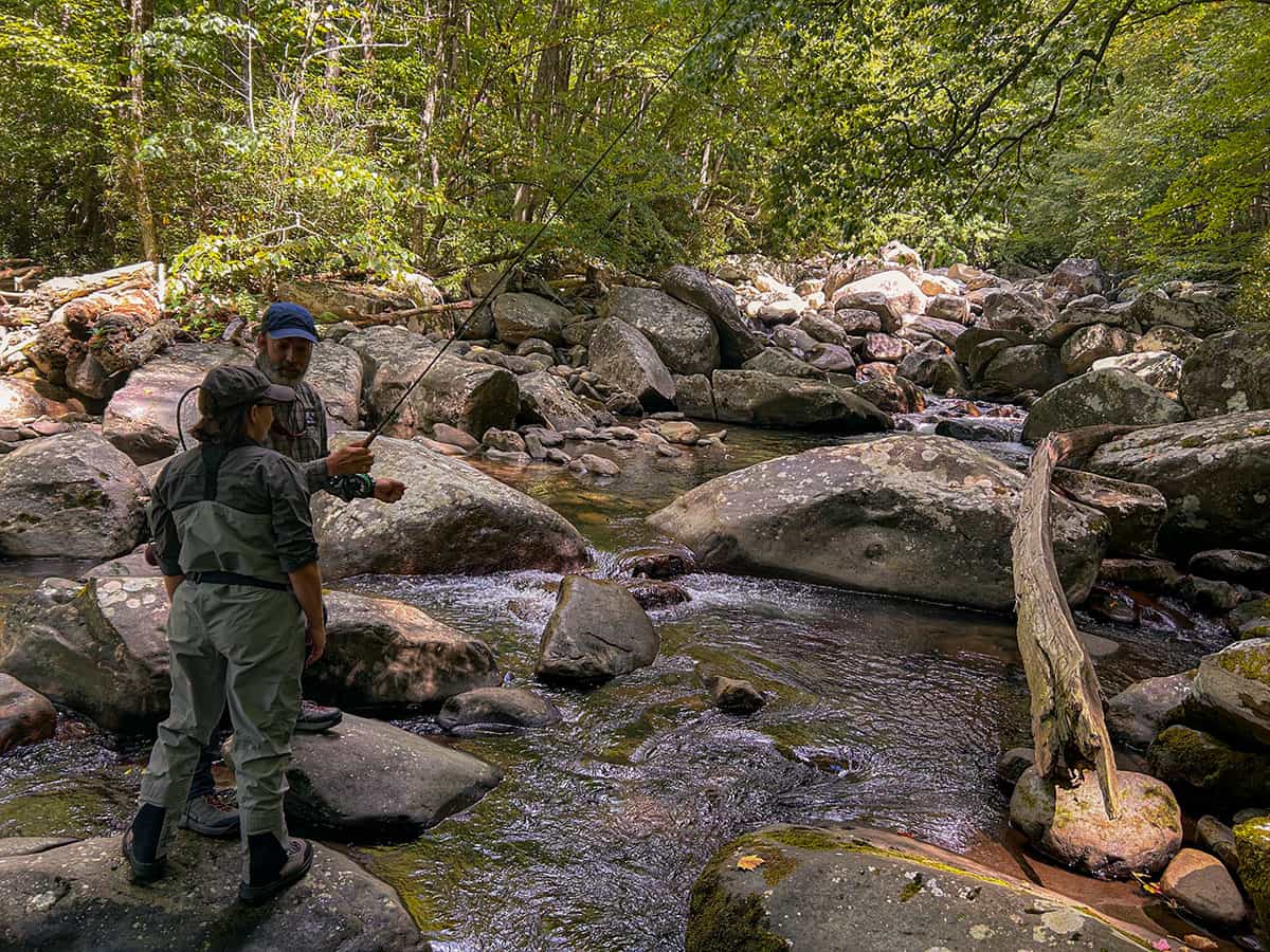 woman and man talking at a stream