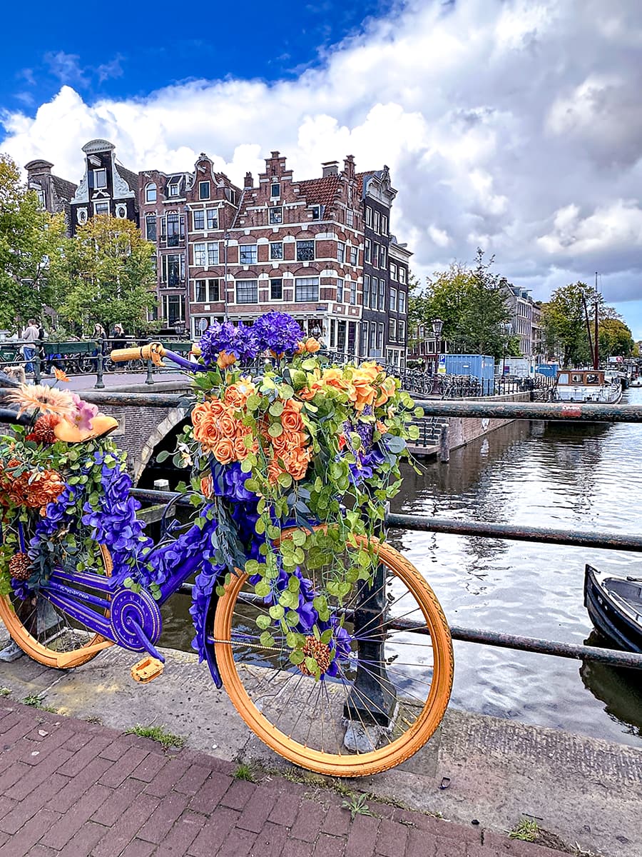 floral bicycle next to Amsterdam canal