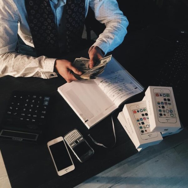 man counting money over books
