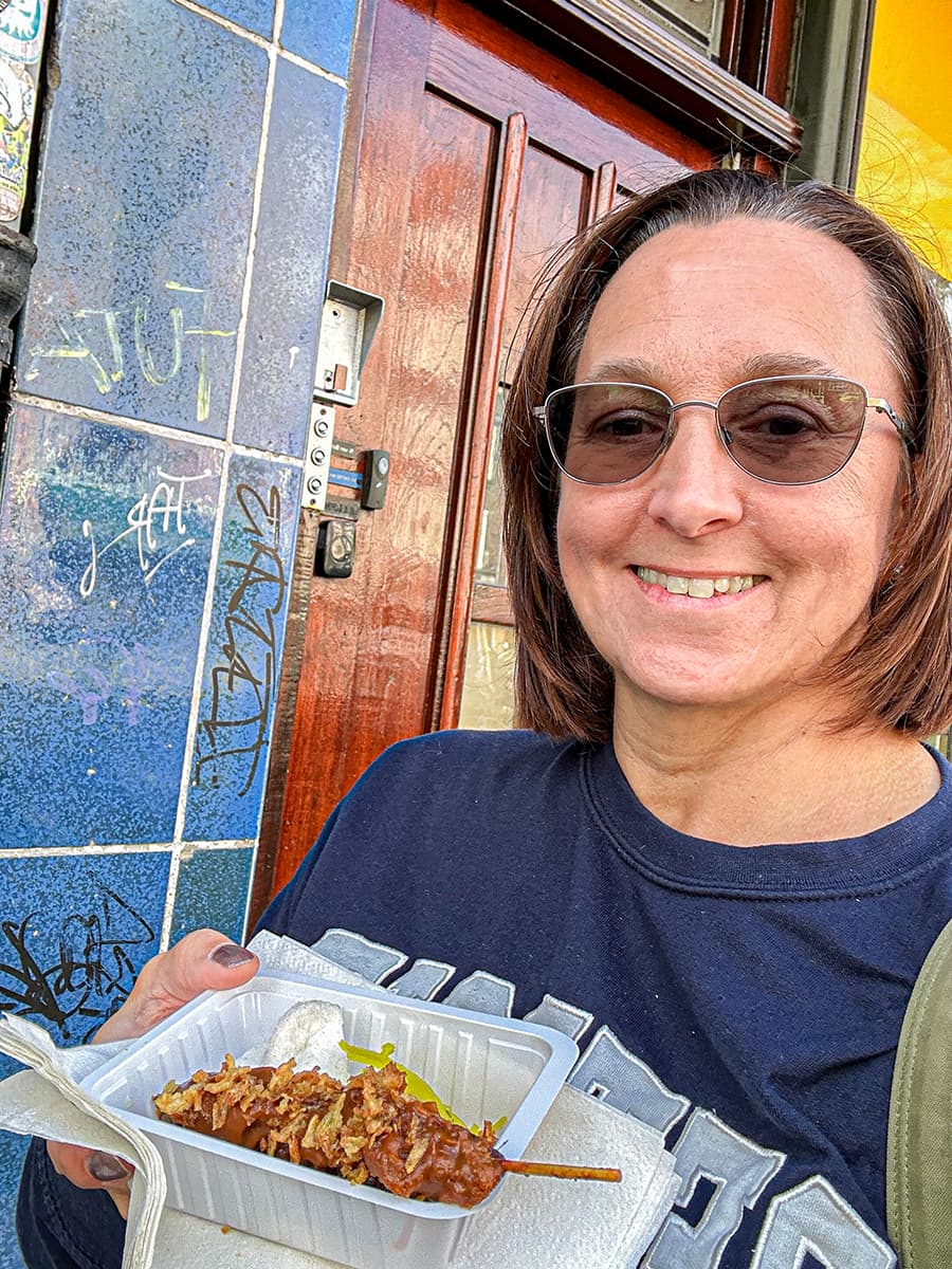 woman holding indonesian satay