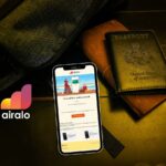 backpack, passport, and phone with airalo esim email shown
