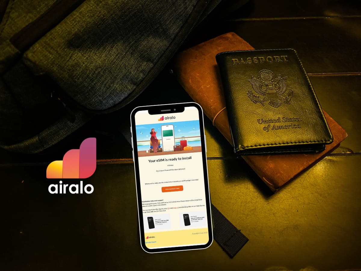 backpack, passport, and phone with airalo esim email shown