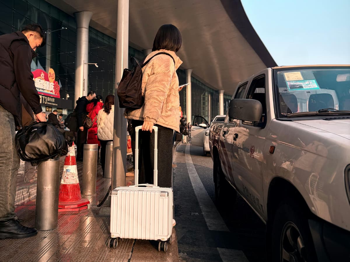 people pulling luggage at airport to get into car