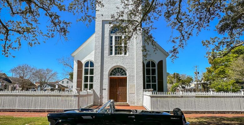 Old Christ Church in Pensacola with vintage car out front
