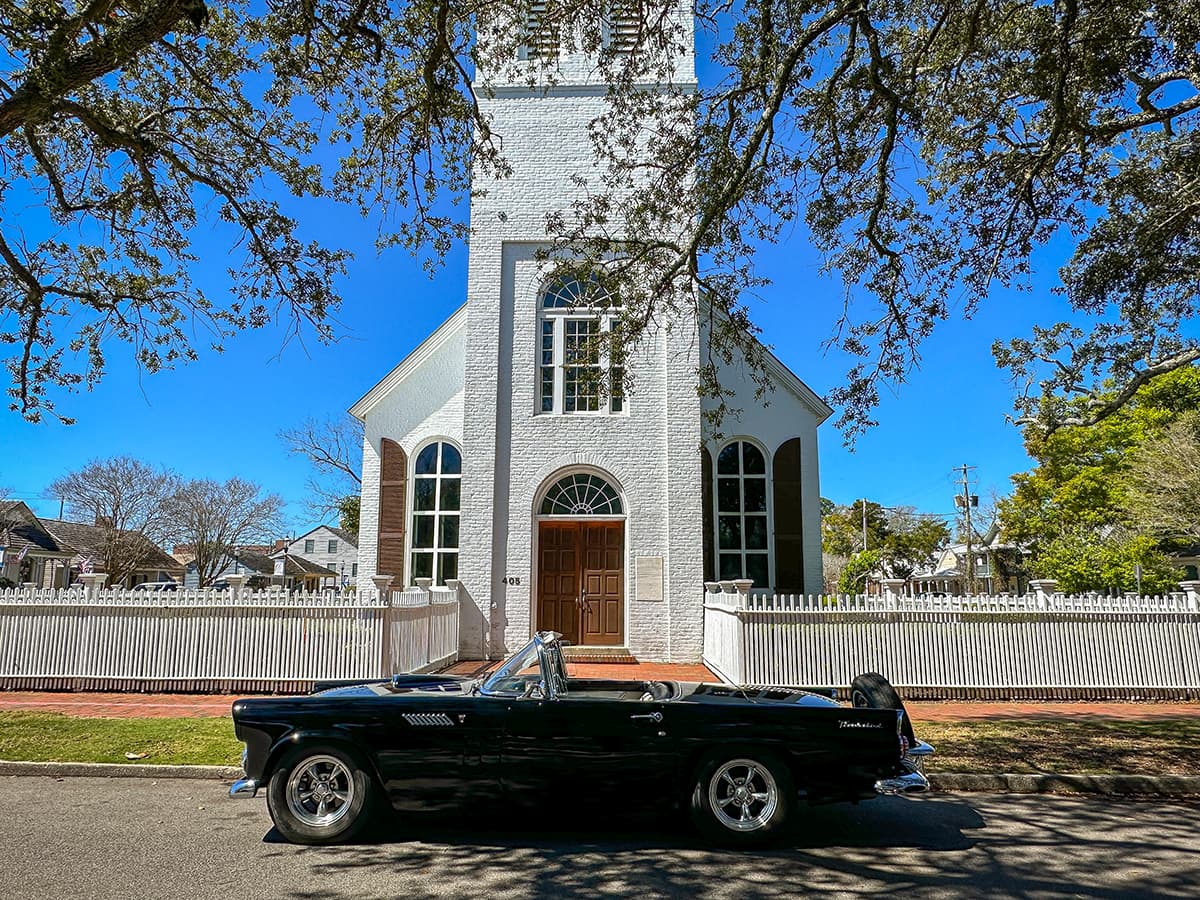 Old Christ Church in Pensacola with vintage car out front