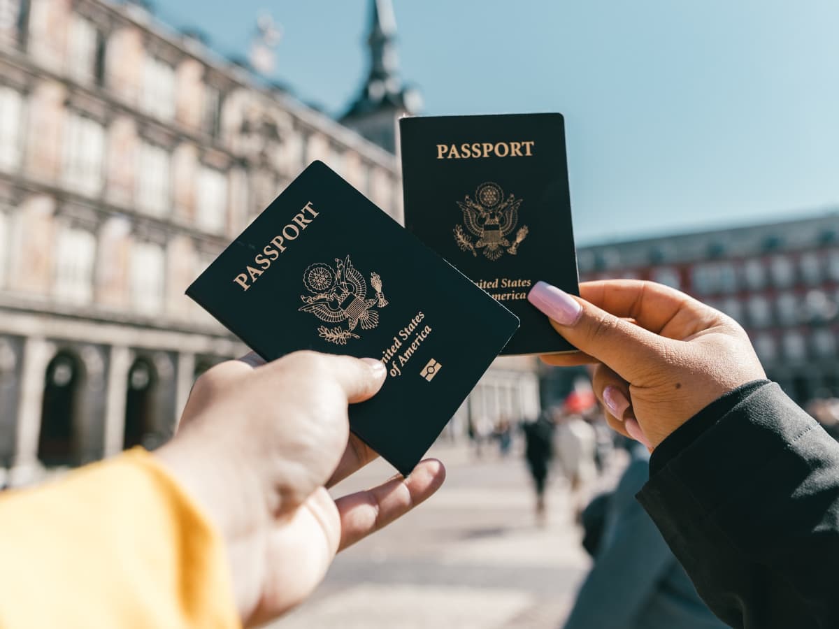 passports held up by hands in Europe