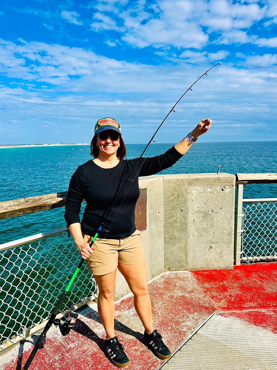 woman golding fishing pole with no fish