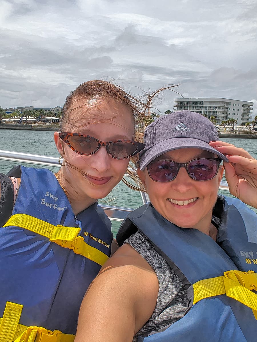 women in a boat with life jackets