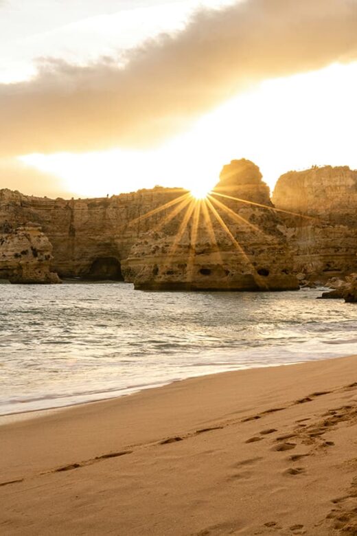 algarve beach with sunset behind rocks