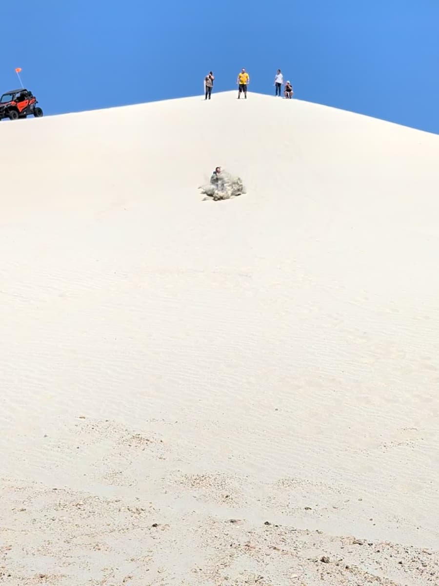 falling while sand surfing in Killpecker Sand Dunes rec area