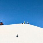sandsledding on a sand dune