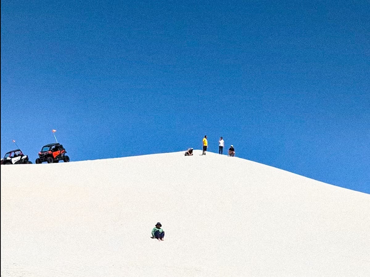 sandsledding on a sand dune