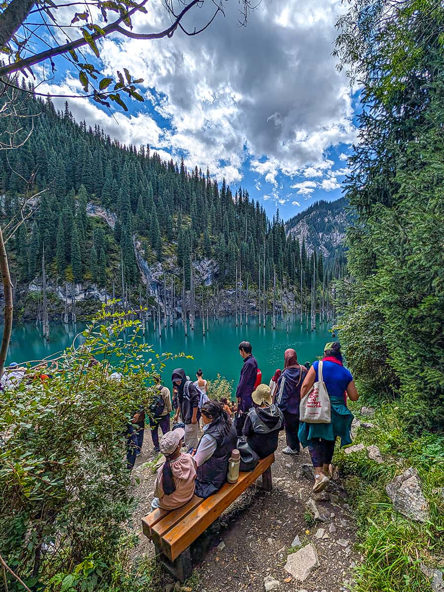 Kaindy Lake with lots of people at lookout