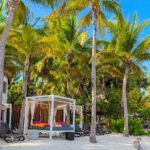 beach cabanas, palm beaches, and lush landscaping in Riviera Maya