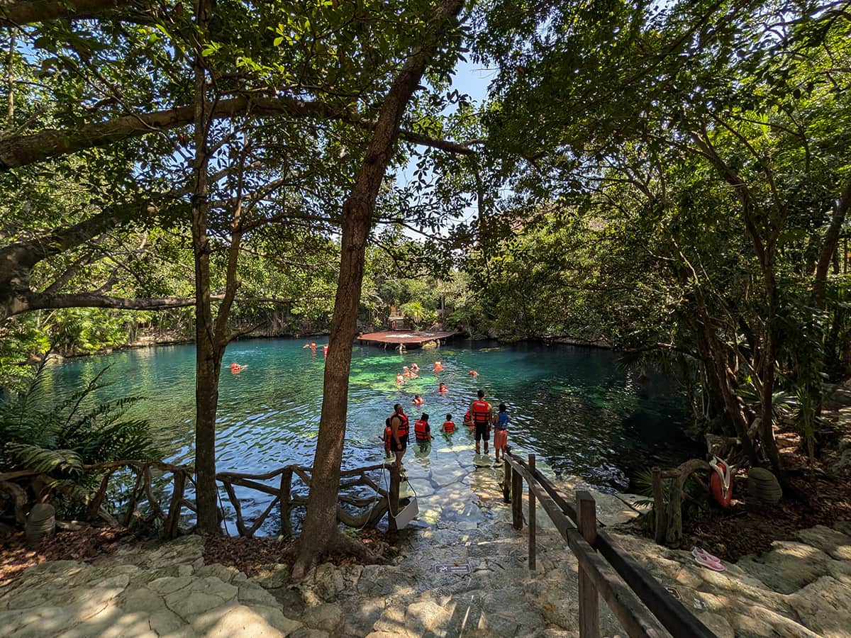 Sandos Caracol swimming cenote with swimmers