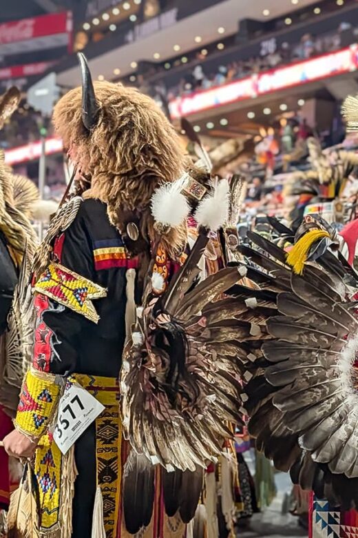 Black Hills Powwow male dancers in regalia waiting to take the floor