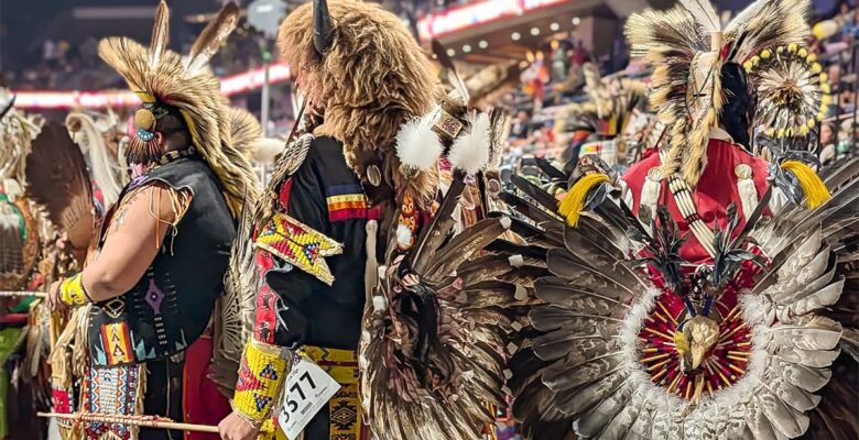 Black Hills Powwow male dancers in regalia waiting to take the floor