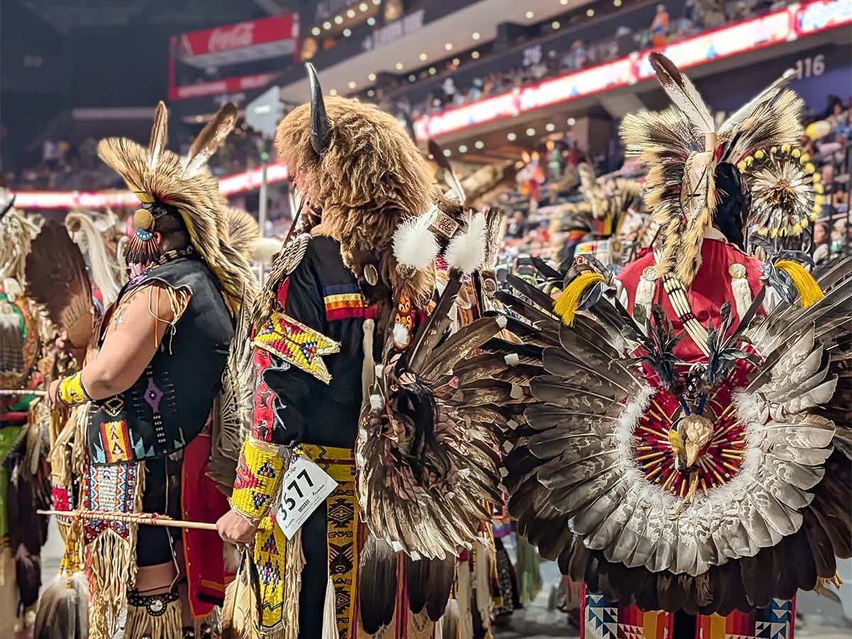 Black Hills Powwow male dancers in regalia waiting to take the floor
