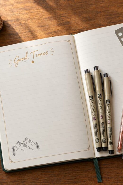 travek journal opened for memories with pens, washi tape, ticket stubs, and glue ready
