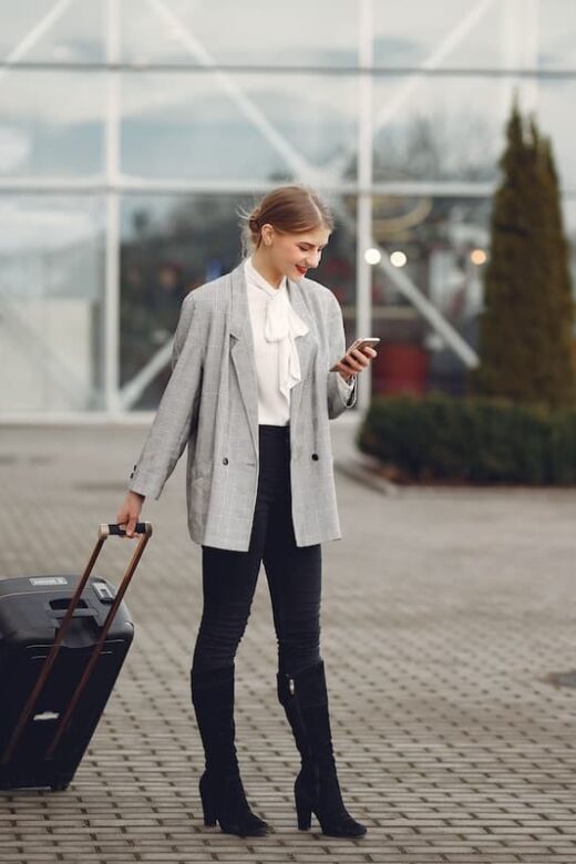 person with suitcase and phone