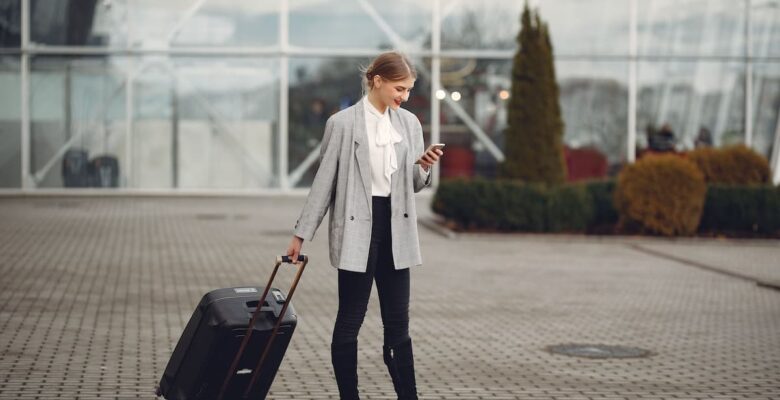 person with suitcase and phone